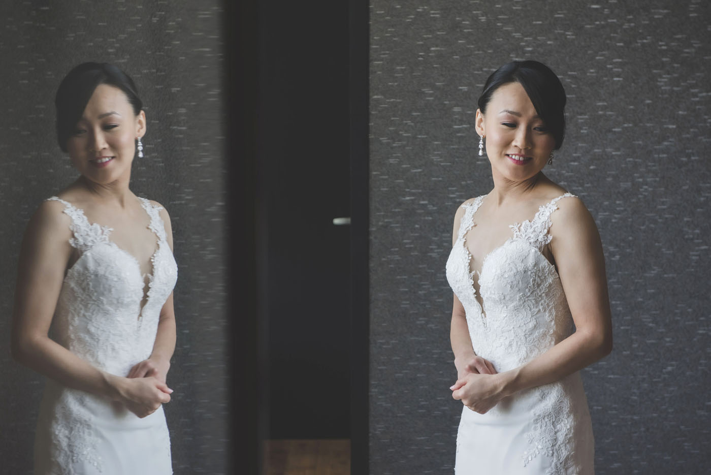 Yuri posing in front of glass window in her wedding dress.